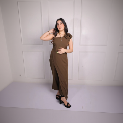 Woman wearing a brown dress against a white wall
